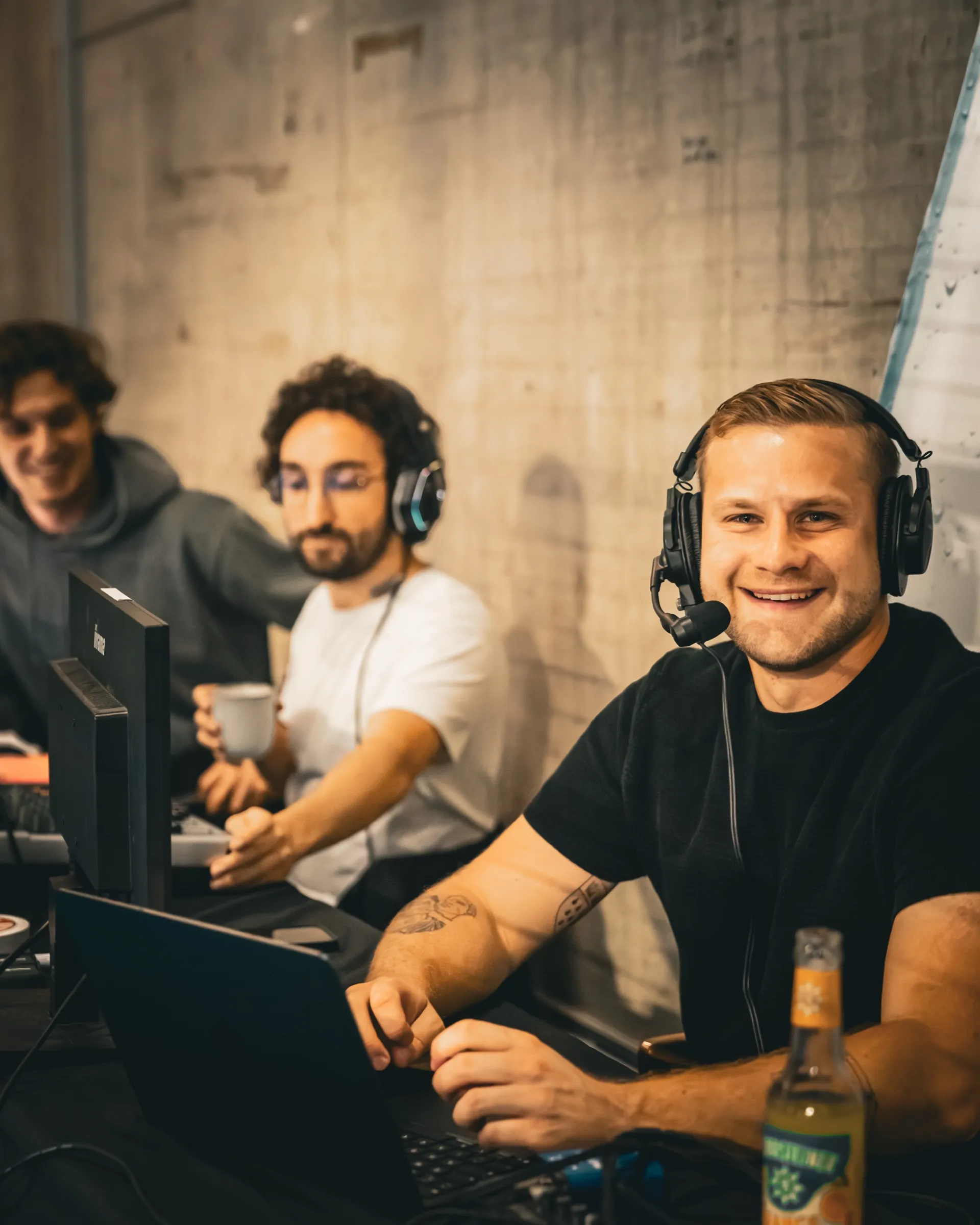 The commentary team with headsets at the broadcast desk during Gerolsteiner Creator × Profi
